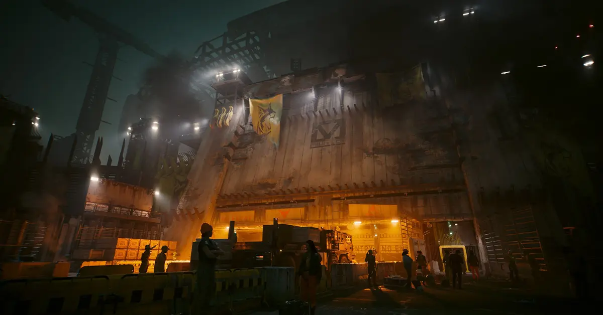 Ein Spielercharakter blickt auf den stark befestigten Eingang zum Dogtown-Bezirk in Cyberpunk 2077